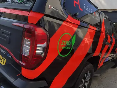 Close-up of First Line Maxus T90 EV pickup wrap with Zero Emission and FL graphics
