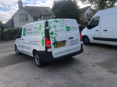 White Mercedes eVito van with Graduate Landscapes electric livery parked on a street