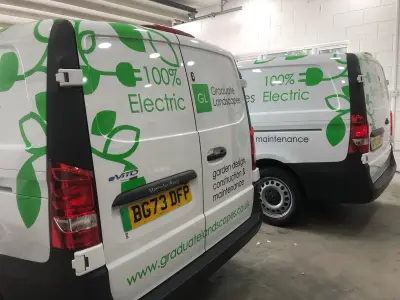 Two white Mercedes eVito Graduate Landscapes electric vans parked rear-on in a garage