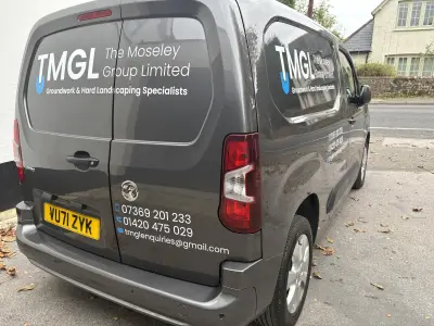 Dark grey Vauxhall Combo van with TMGL The Moseley Group Limited groundwork and landscaping graphics