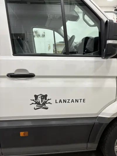 White VW Crafter cab door with black Lanzante elephant logo and wordmark graphic