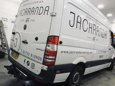 White Mercedes Sprinter van rear with Jacaranda Creative Catering graphics and contact details