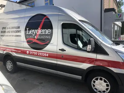Silver Ford Transit van with Leydene Glass and Glazing graphics outside the V Signs shopfront