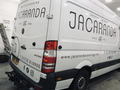 White Mercedes Sprinter van rear quarter with Jacaranda Creative Catering signwriting graphics