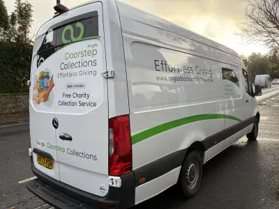 Silver Mercedes Sprinter van rear quarter with Anglo Doorstep Collections charity graphics