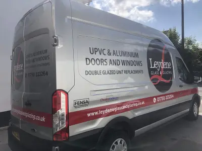 Silver Ford Transit van rear quarter with Leydene Glass and Glazing UPVC and aluminium graphics