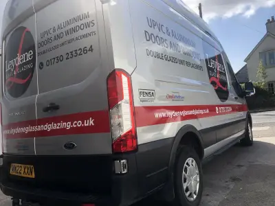 Silver Ford Transit van rear with Leydene Glass and Glazing signwriting and red stripe