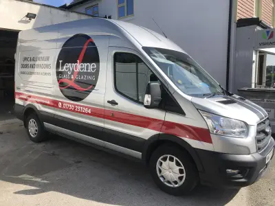 Silver Ford Transit van side with Leydene Glass and Glazing graphics by the V Signs shopfront