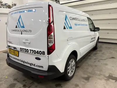 White Ford Transit Connect van rear quarter with Commercial Glazing Ltd signwriting graphics