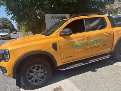 Orange Ford Ranger Wildtrak pickup with green Fordingbridge inspiring design and build door graphics