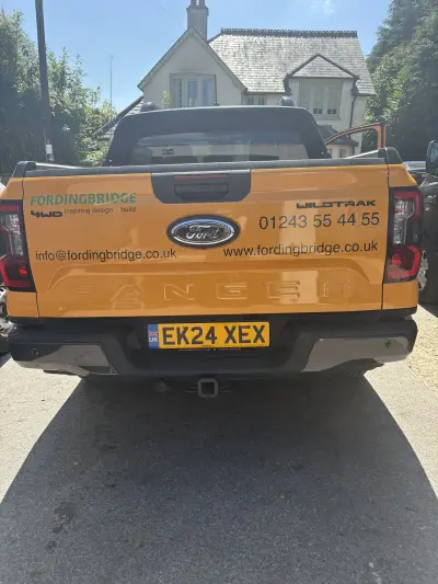 Orange Ford Ranger Wildtrak tailgate with Fordingbridge design and build graphics and contact details