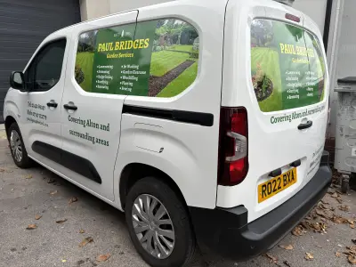 White Peugeot van with Paul Bridges Garden Services window graphics and green side signwriting