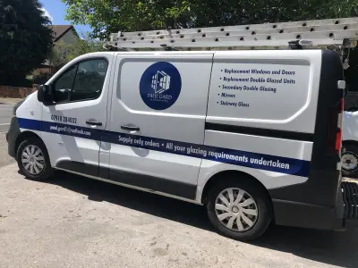 White Vauxhall Vivaro van with Paul Gard Glass & Glazing side graphics and roof ladder rack