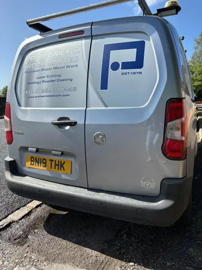 Rear of silver Vauxhall Combo van signwritten for Protec Metal Work Limited, blue P logo