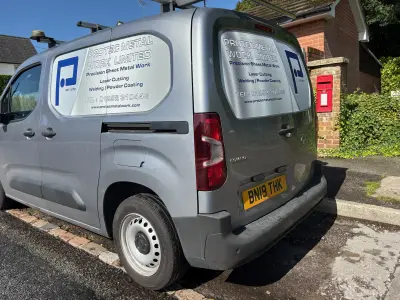 Silver Vauxhall Combo van with Protec Metal Work Limited signage on rear window graphics