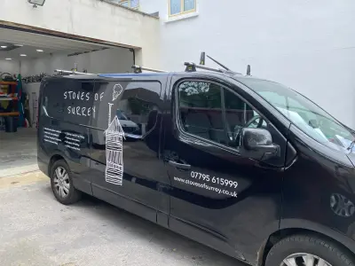 Black Renault Trafic van with white Stoves of Surrey chimney graphics and service list signwriting