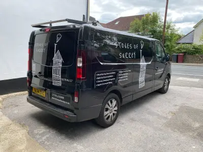 Rear three-quarter of black Renault Trafic van signwritten for Stoves of Surrey