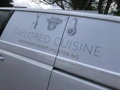 White van door with Taylored Cuisine catering graphics and etched highland-cow and squash illustrations