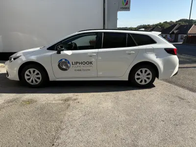 White Toyota Corolla Touring Sports estate with Liphook Equine Hospital door graphics