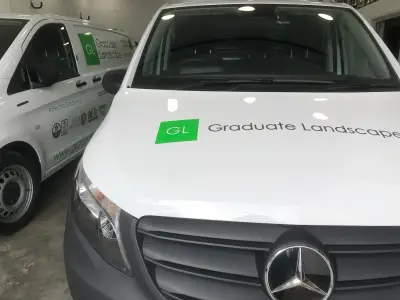 White Mercedes Vito vans with green Graduate Landscapes signwriting on bonnet and sides