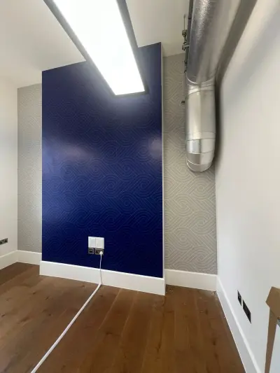 Office alcove with navy swirl-patterned wall vinyl and matching grey walls