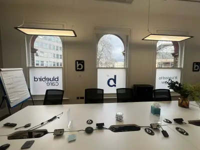 Bluebird Care meeting room with frosted window graphics showing the logo and strapline