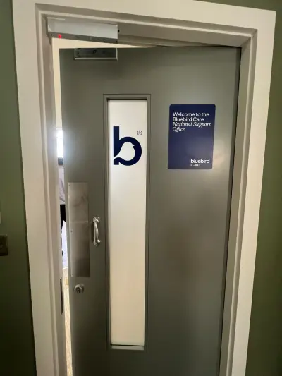 Grey office door with Bluebird Care 'b' logo and Welcome to the National Support Office sign