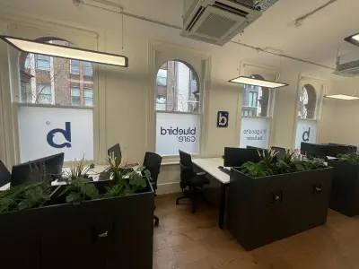 Bluebird Care office with frosted window graphics reading 'It's good to be home' and logo lower panels