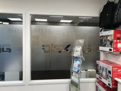 Disking computer shop window with frosted band and cut-out 'DISKING' lettering