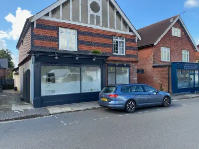 G20 Group shopfront with frosted window graphics; blue VW estate parked outside on Hampshire street