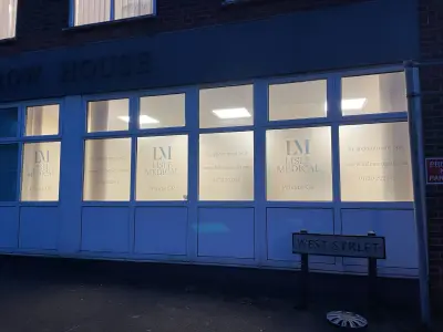 Lisle Medical illuminated frosted window graphics at night on West Street