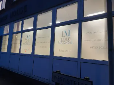 Lisle Medical frosted window graphics with logo and phone number lit at night