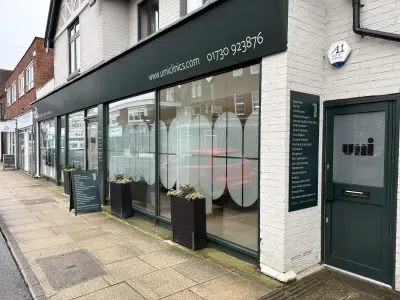Umi Clinic shopfront with frosted oval window graphics and services panel in Hampshire