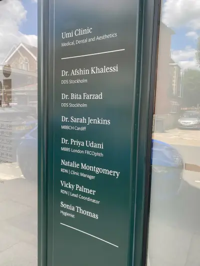 Umi Clinic frosted glass panel listing clinicians' names and qualifications