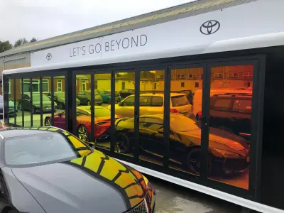 Toyota mobile showroom trailer with Let's Go Beyond signage and gradient-tinted glazing panels