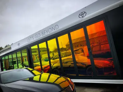 Angled view of Toyota Let's Go Beyond mobile showroom with rainbow gradient window film
