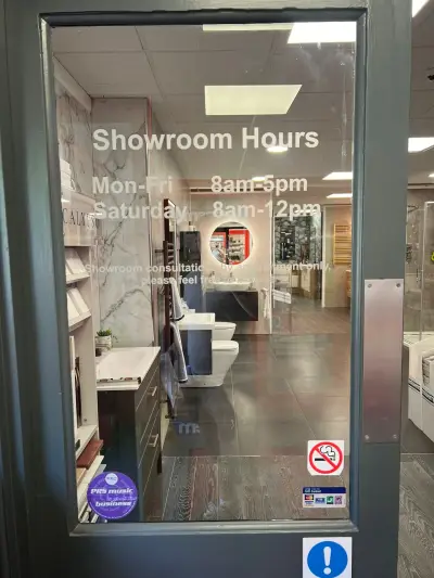 Bathroom showroom glass door with white vinyl Showroom Hours opening-times lettering