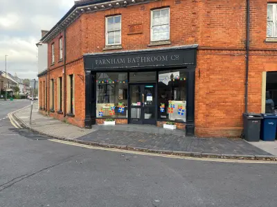 Farnham Bathroom Co corner shopfront with festive gift-box window graphics and bunting