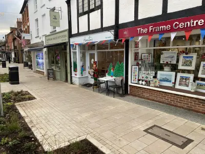 Farnham parade shops including Hamilton's tea house and The Frame Centre with bunting