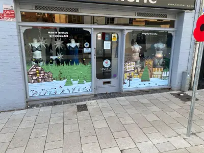 Loncherie lingerie shopfront with painted snowy village-scene window graphics and mannequins