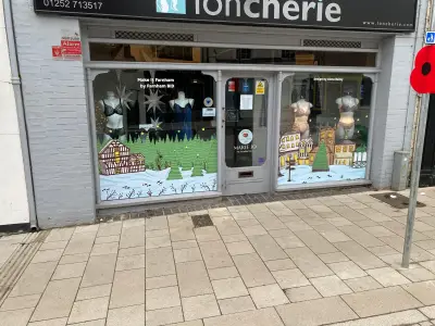 Loncherie lingerie shopfront with festive winter-village window graphics under fascia sign