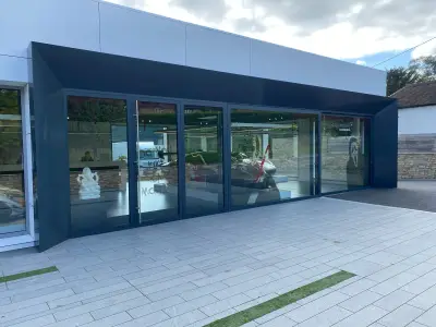 McLaren Petersfield showroom exterior with Halloween blood-splatter and Scream mask window graphics