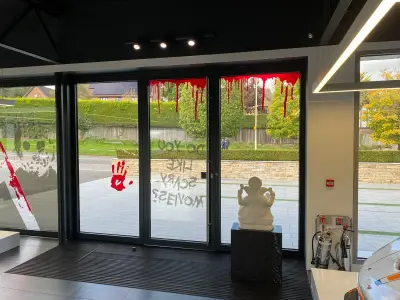 Showroom doors with red blood-drip and Do You Like Scary Movies Halloween window graphics