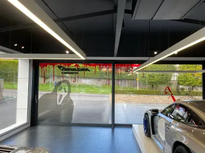McLaren showroom glazing with blood-drip McLaren logo and Scream mask Halloween window graphics