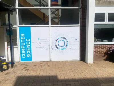 Building windows with white and blue Computer Science branded circuit-design window graphics