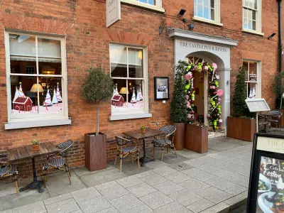 The Castle Pub & Dining red-brick frontage with festive gingerbread and candy-cane window graphics