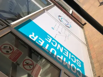 Computer Science window graphic with circuit design on a school building, seen reversed