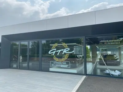 McLaren Petersfield showroom window with gold GTR Le Mans 1995 30th Anniversary graphic