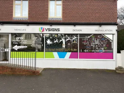 VSigns showroom with Christmas window graphics of Santa's sleigh, reindeer and snowflakes