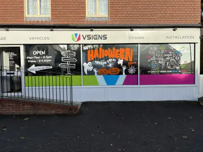 VSigns showroom frontage with Halloween window graphics of pumpkins, ghosts and cobwebs